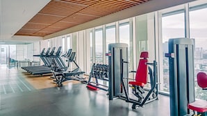 A modern gym with treadmills, dumbbells, and weight machines. - Gorgeous 1Br Apartment At The Smith Alam Sutera (Tangerang)