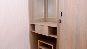 A wooden wardrobe with a mirror and a single drawer. - Nice And Best Deal 2Br At Green Pramuka City Apartment (Jakarta)