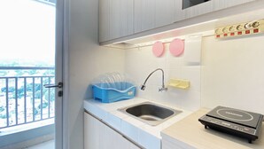 Moderni keittiö, jossa on pesuallas, sisäänrakennettu uuni ja parveke, jolta on näkymä.