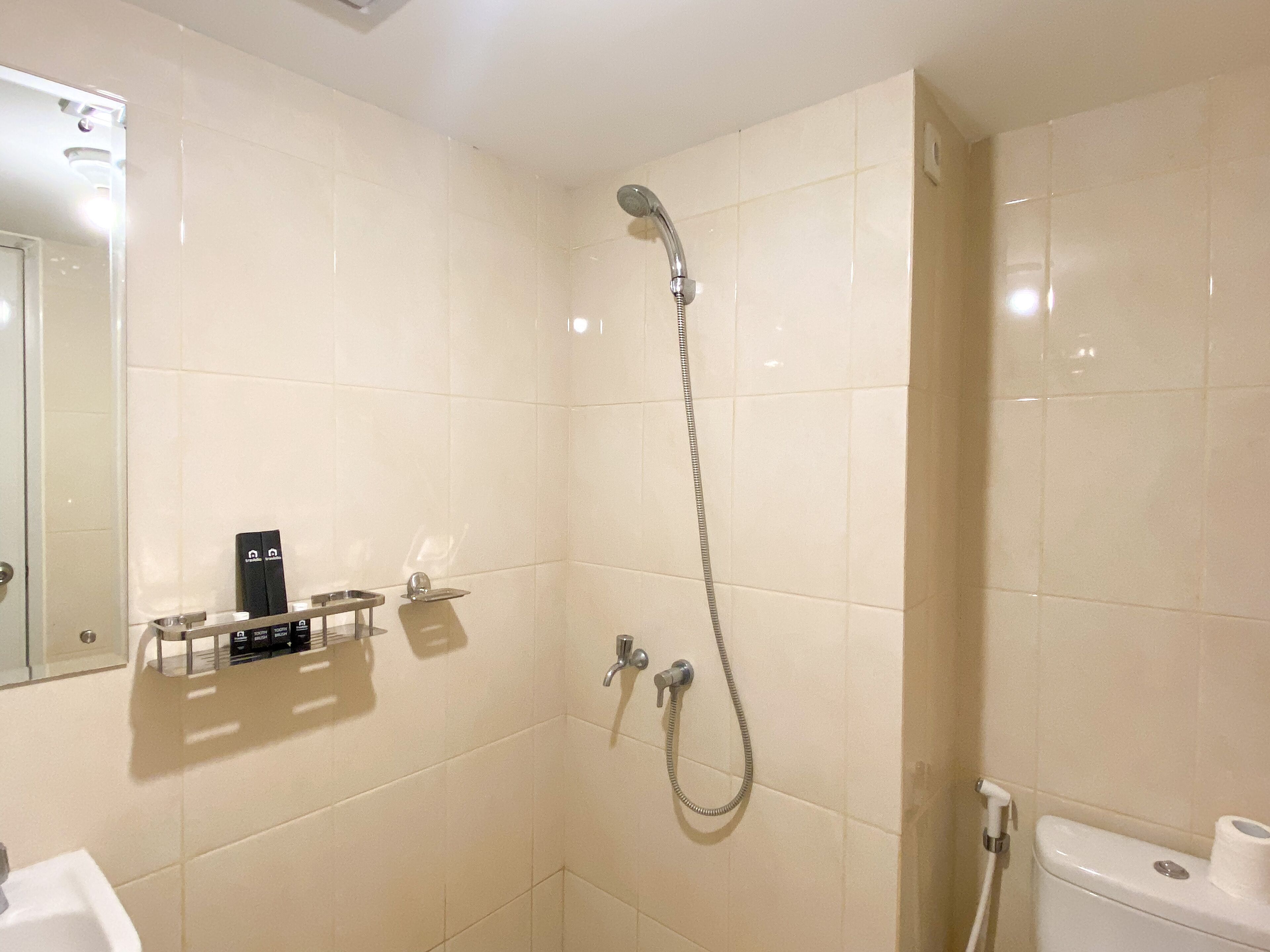 Une salle de bain avec douche, toilettes et lavabo.