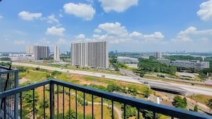 A high-rise building with multiple floors, surrounded by greenery and a clear sky. - Simply And Modern Studio At Casa De Parco Apartment (Pagedangan)