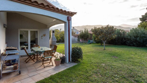 A patio with a table and chairs, a grill, and a small cart with kitchen items. - La Massane - Three Bedroom House, Sleeps 6 (Argeles-sur-Mer)