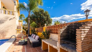 A patio with a pool, outdoor seating, and a brick oven. - Villa Las Palomas - Three Bedroom Villa, Sleeps 6 (Frigiliana)