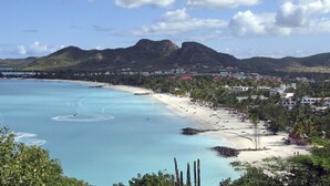 A coastal town with a beach, clear blue waters, and mountains in the background. - Calabash 4 Bedroom Villa - Stunning Sea Views, Private Pool, Delightful Location (Darkwood Valley)