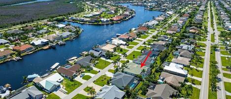 An aerial view of Tarpon Point Marina with residential areas, water bodies, and a marina.