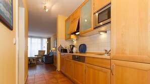 A kitchen with wooden cabinets, a microwave, and a dishwasher.