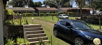 Rustic, farm house space surrounded by trees and near a river.