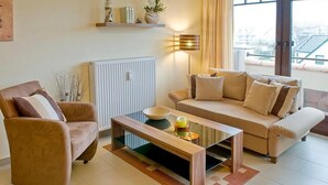 A modern living room with a sofa, armchair, and coffee table.
