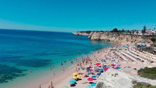 A beach with numerous colorful umbrellas and people enjoying the water. - Kine Villa, Armação de Pêra, Algarve (Armação de Pêra)
