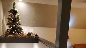 A staircase with a Christmas tree and a wooden chair. - Serenity between the lakes and seashore (Westbrook)