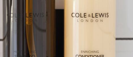Two bottles of Cole & Lewis London conditioner and moisturizing shampoo.