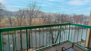 A balcony with a view of a river and trees. - Dolly Dreams - Fireplace, Minutes to Dollywood! (Pigeon Forge)