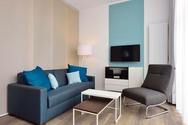 Wohn/ Essbereich mit Couch, Sessel und Fernseher