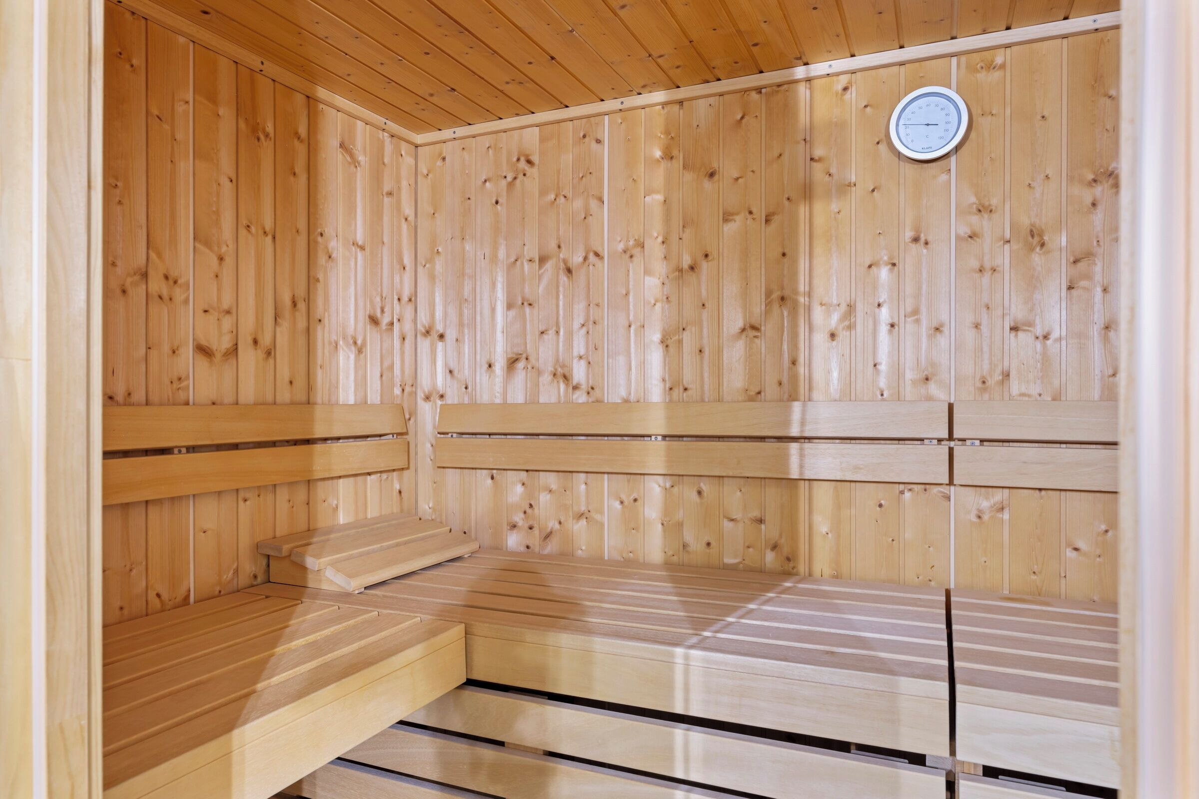 A sauna with wooden walls and benches.