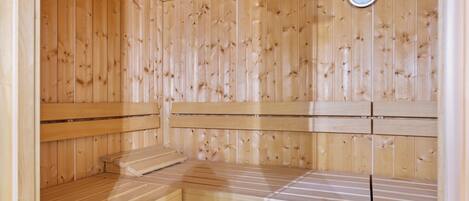 A sauna with wooden walls and benches.