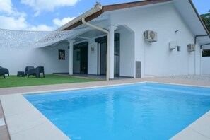 Relax by the pool surrounded by a covered patio area.