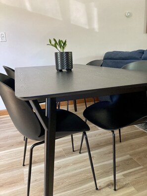 Enjoy meals in this stylish dining area with a sleek table and comfortable chairs.