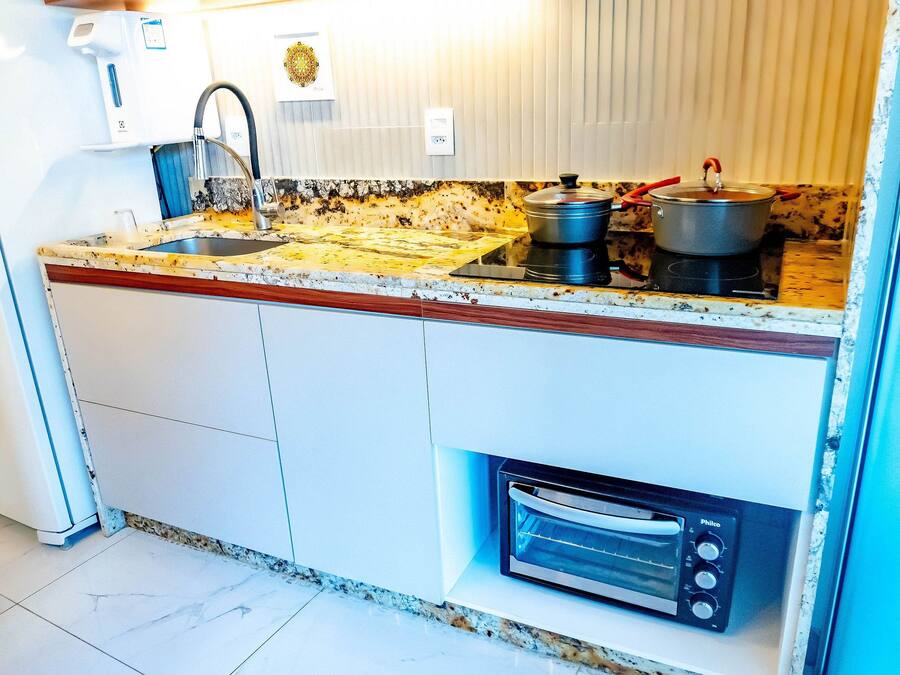 A kitchen with a sink, stove, and oven.