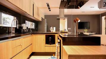 Departamento Deluxe, 2 habitaciones, 2 baños, planta baja | Cocina privada | Refrigerador, microondas, utensilios de cocina y artículos de limpieza