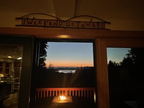Enjoy a peaceful view of the surrounding water from the comfort of your room, where a warm fire crackles in the fireplace.
