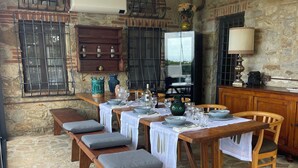 A stone-floored dining area with wooden benches and tables set for a meal. - Farmhouse with beautiful pool and jacuzzi, panoramic location in chianti (castellina in chianti)