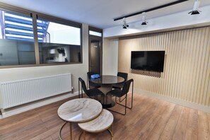 Luxury Quadruple Room | Living area | 50-inch Smart TV with cable channels, TV - Goodwin (London)