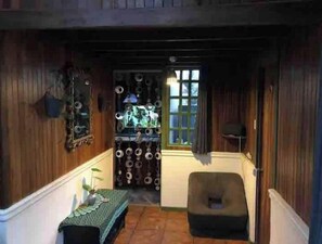 Cozy room with a sloped ceiling, wooden paneling, and a table with a tablecloth.