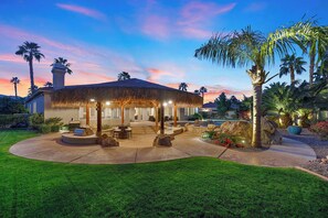 A house with a covered outdoor area featuring a barbecue, seating, and a pool. - Endless Summer - Swim up bar & waterslide! (Indio)