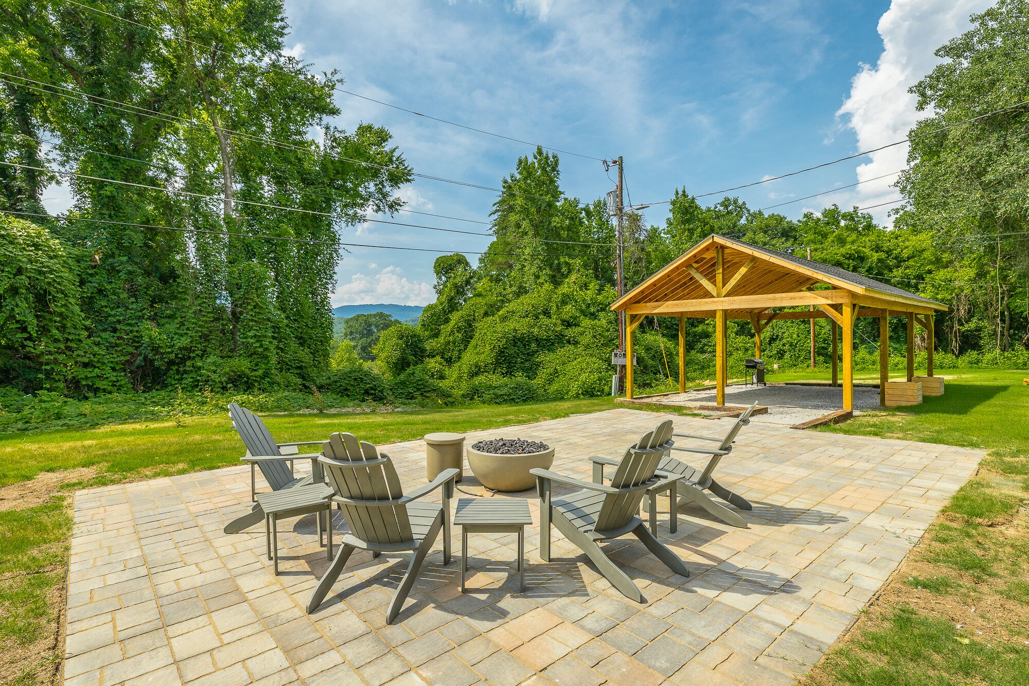 A patio area with outdoor furniture and a covered pavilion.