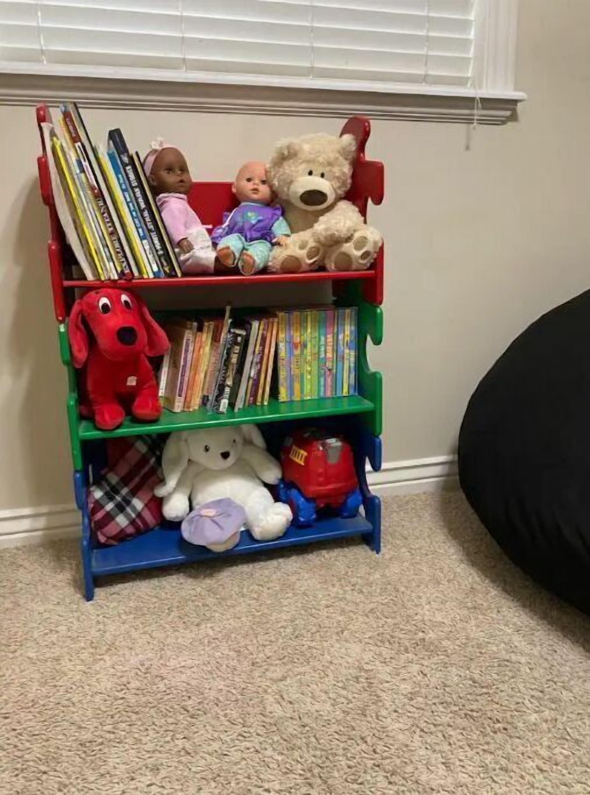 A bookshelf with books and stuffed toys.