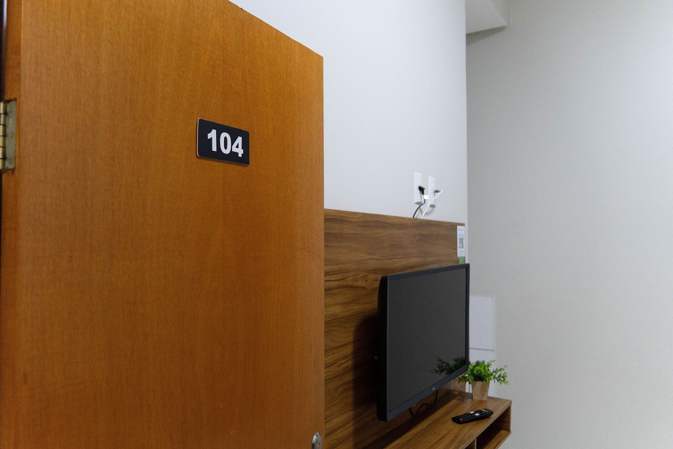 A reception desk with a sign indicating room number 104.