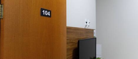 A reception desk with a sign indicating room number 104.