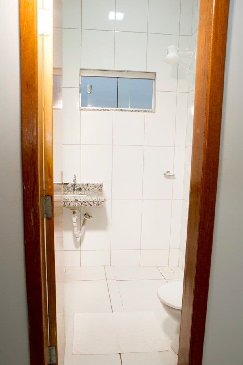 A small bathroom with a sink, toilet, and a mirror above the sink.