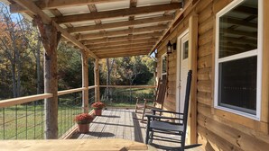 A wooden deck with a pergola, potted plants, and outdoor furniture. - The Stillhouse Cabin, mins from Red River Gorge (Campton)