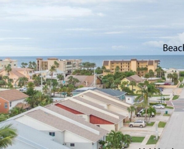 A residential area with a road leading to the beach.