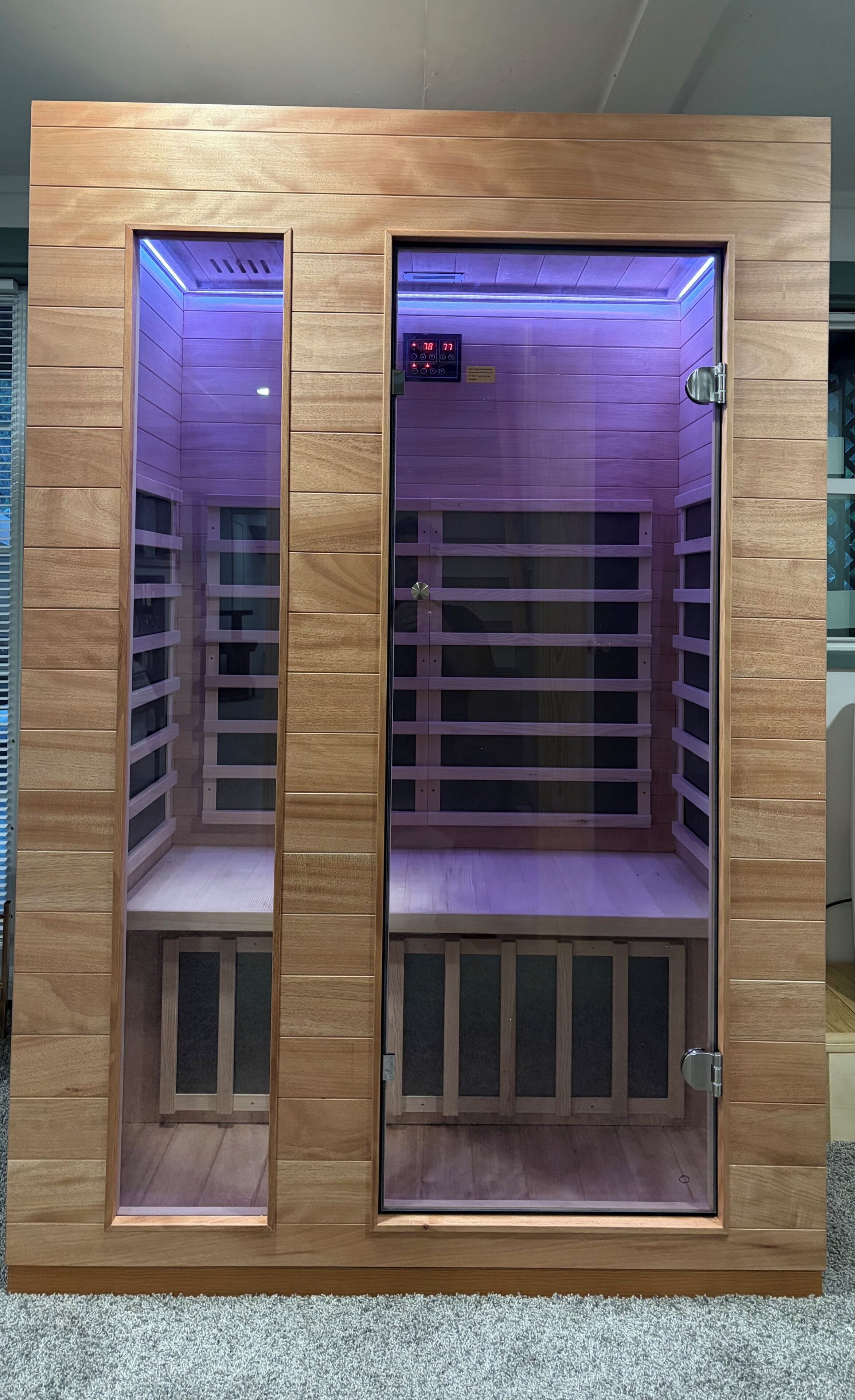 Two wooden cabinets with glass doors, each containing a digital display and a control panel.