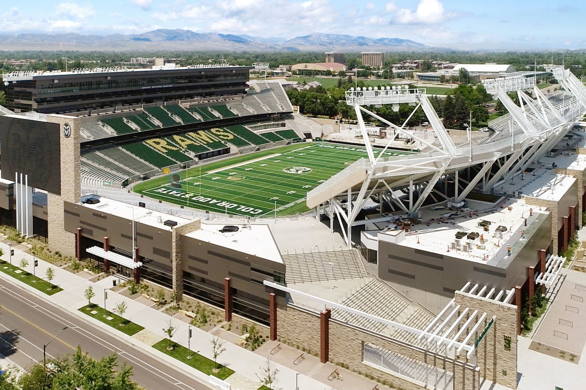 A football stadium with a large seating area, a field, and a modern architectural design.