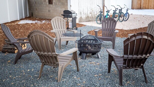 An outdoor seating area with Adirondack chairs, a fire pit, and a grill. - Cozy Carriage House, Walk to UNC, Free Bikes (Greeley)