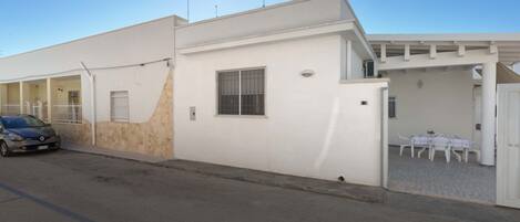A modern building with a car parked in front.