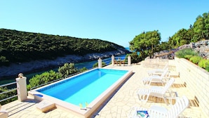 A swimming pool with lounge chairs and a view of the sea. - Oasis of Peace (Korcula)