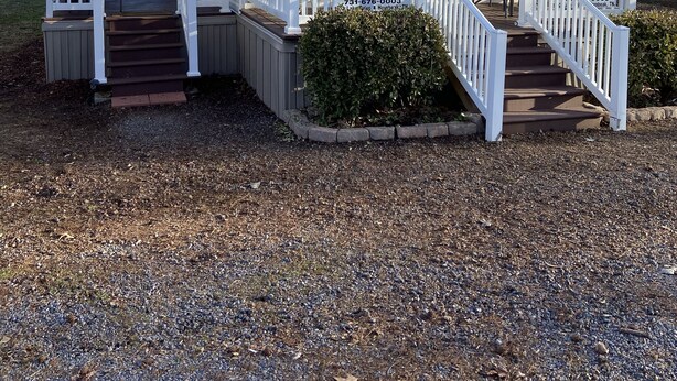 A two-story building with a porch and a covered area, labeled "The Duck Nest Lodge."