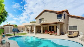 A house with a swimming pool, patio furniture, and a covered outdoor seating area. - 1 Mi to Surprise Stadium! Home w/ Patio & Hot Tub (Surprise)