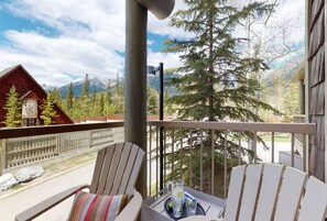 Relax on the balcony with a refreshing drink, taking in the breathtaking views of the surrounding mountains and forest.