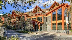 A modern building with large windows and a stone facade. - AURORA NIGHTS -  COZY LIVING -  SPA, POOL & HOT TUB (Canmore)
