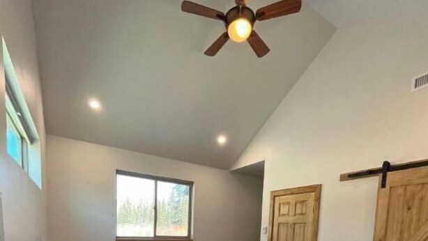 A bedroom with a bed, a nightstand, a lamp, a ceiling fan, wooden flooring, a window, and a door. -   Private Mtn Room 1/4 mi from Purgatory.  Perfect Base Camp! (Durango)