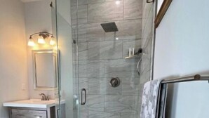 A modern bathroom with a glass-enclosed shower, a vanity with a mirror, and a wooden floor. -   Private Mtn Room 1/4 mi from Purgatory.  Perfect Base Camp! (Durango)