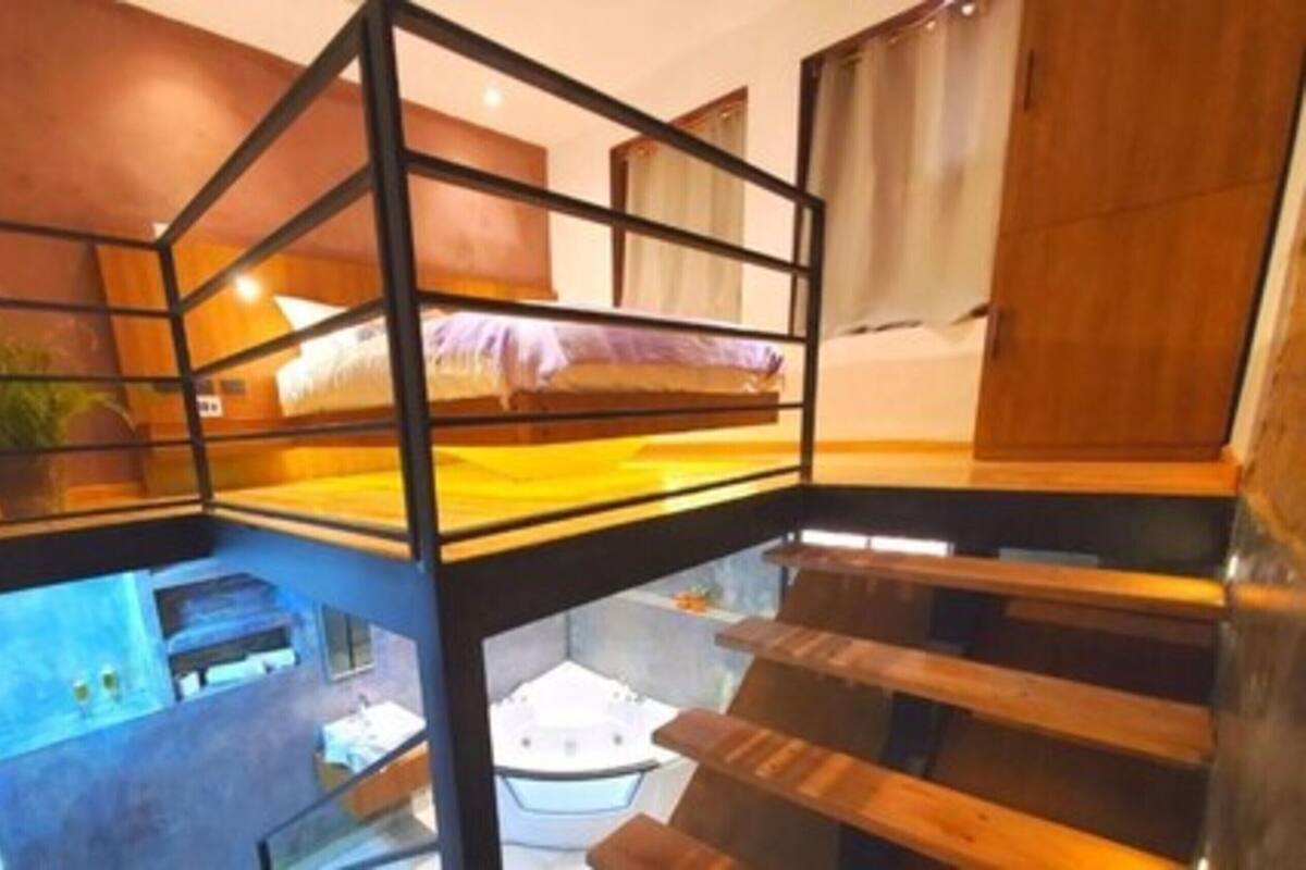 A bunk bed with a wooden frame and a view of a lower level.