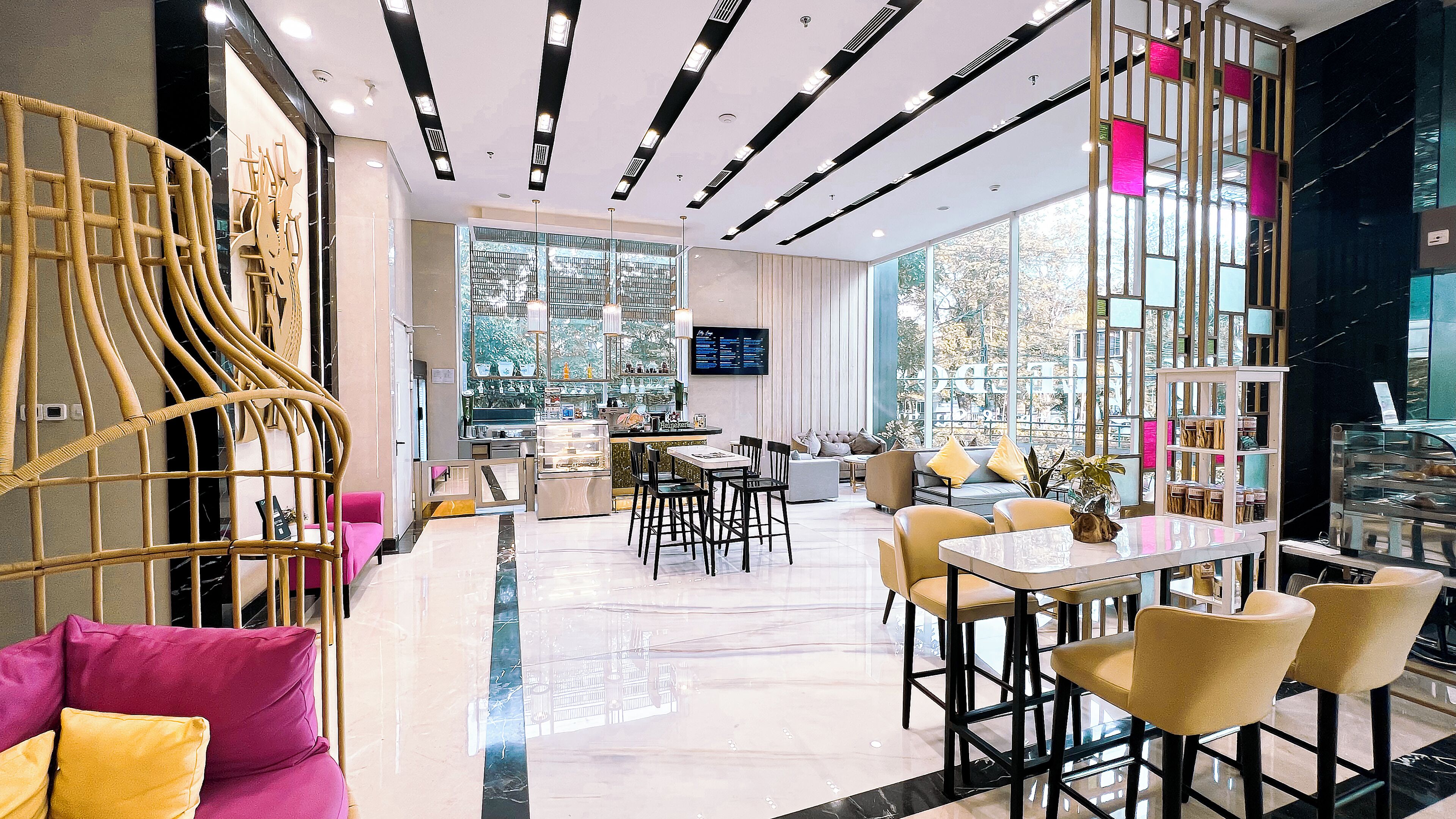 A modern interior with a dining area, bar, and seating with a view.