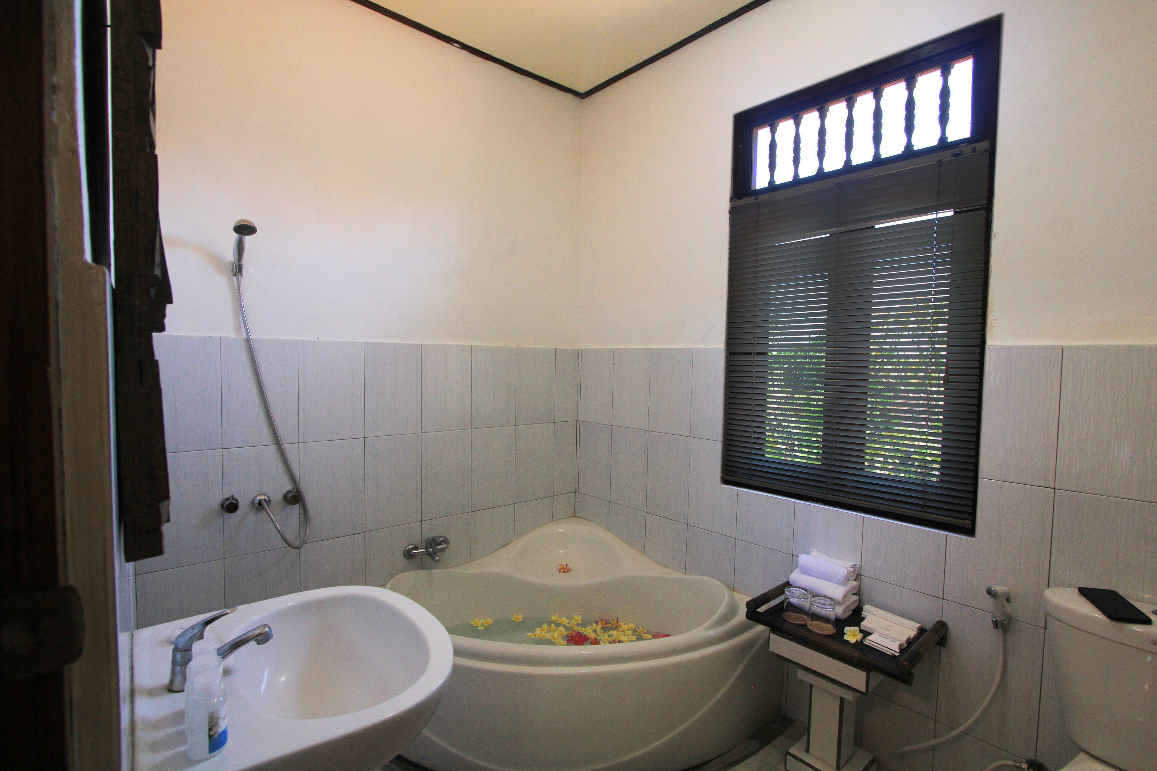 A bathroom with a bathtub, a sink, and a toilet.