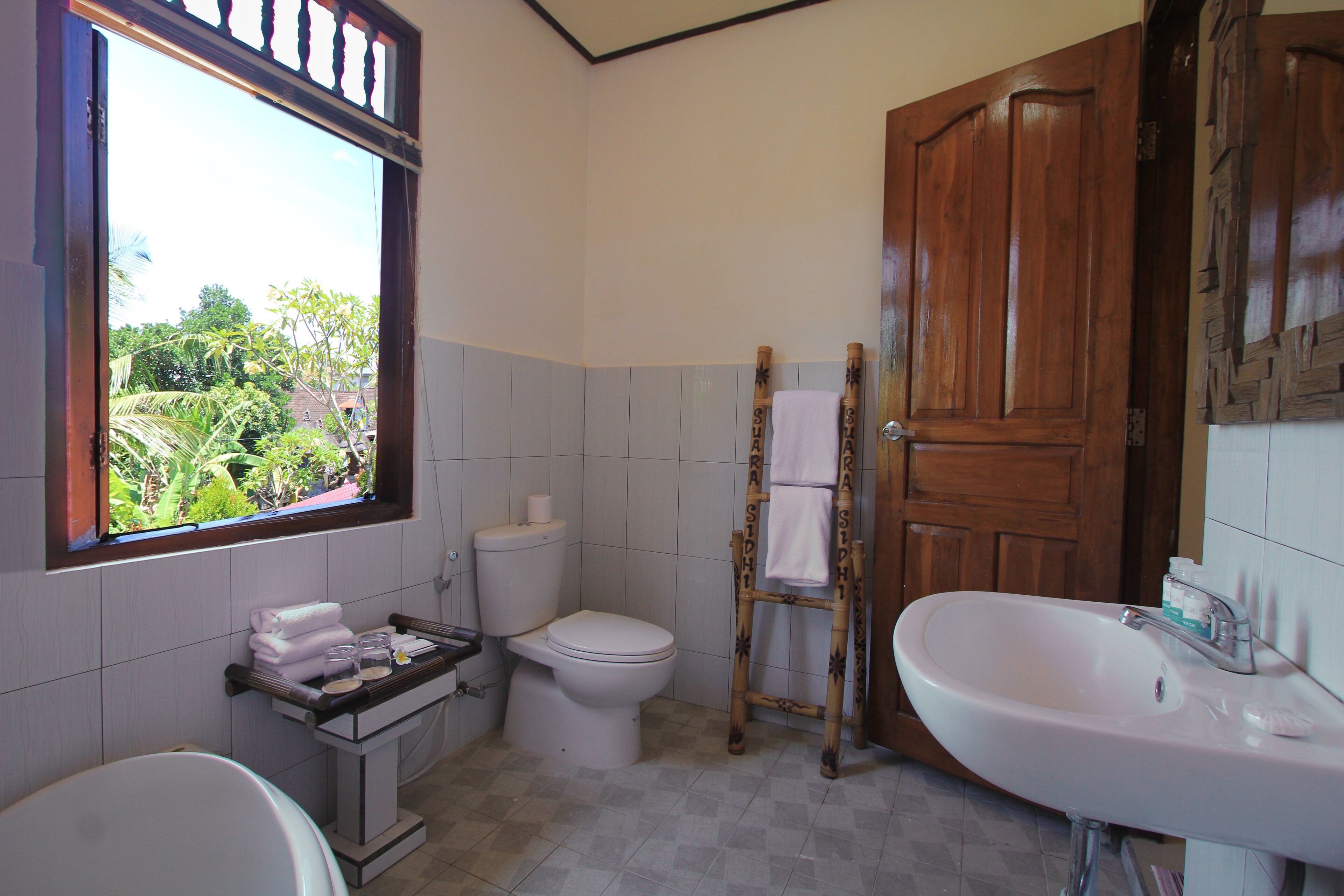 Ein Badezimmer mit Toilette, Waschbecken und Fenster.